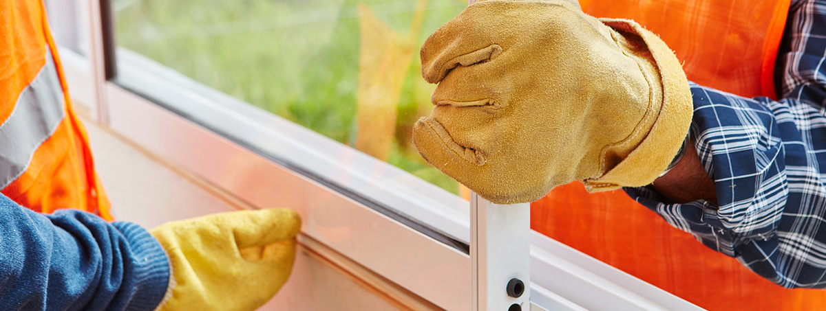 Two workers installing window