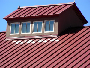 Four windows reflecting sunlight on to a roof