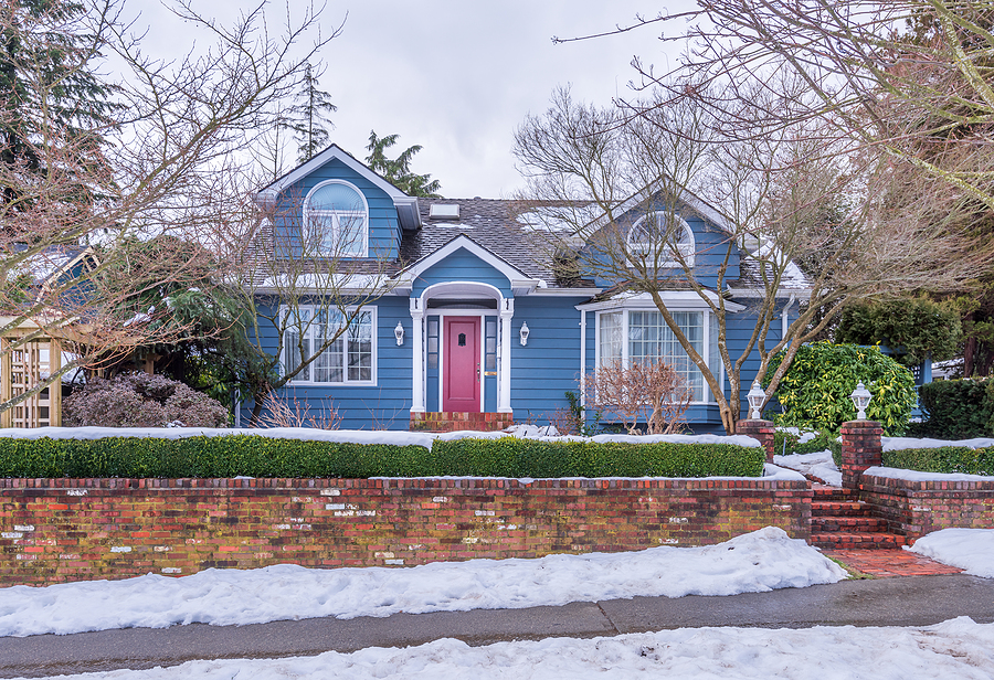 An old american house in winter. Snow covered.