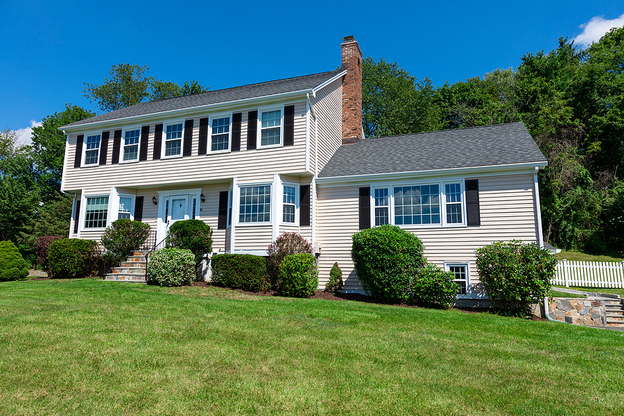 American traditional Colonial house front view in summer