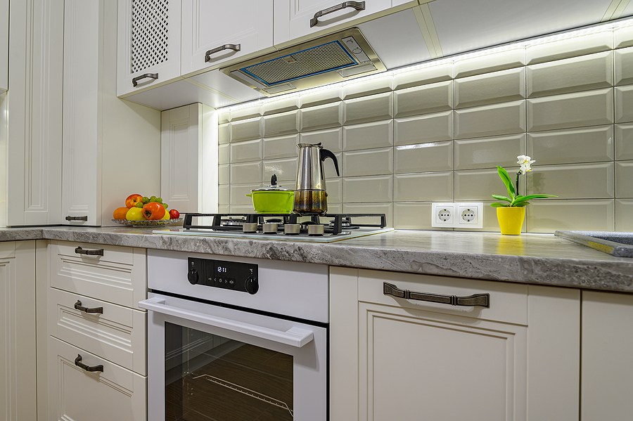 Cozy modern kitchen with great lighting and bright white tile backsplash.