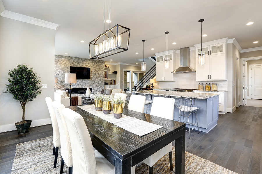 Beautiful modern kitchen in luxury home interior with large island and stainless steel appliances.