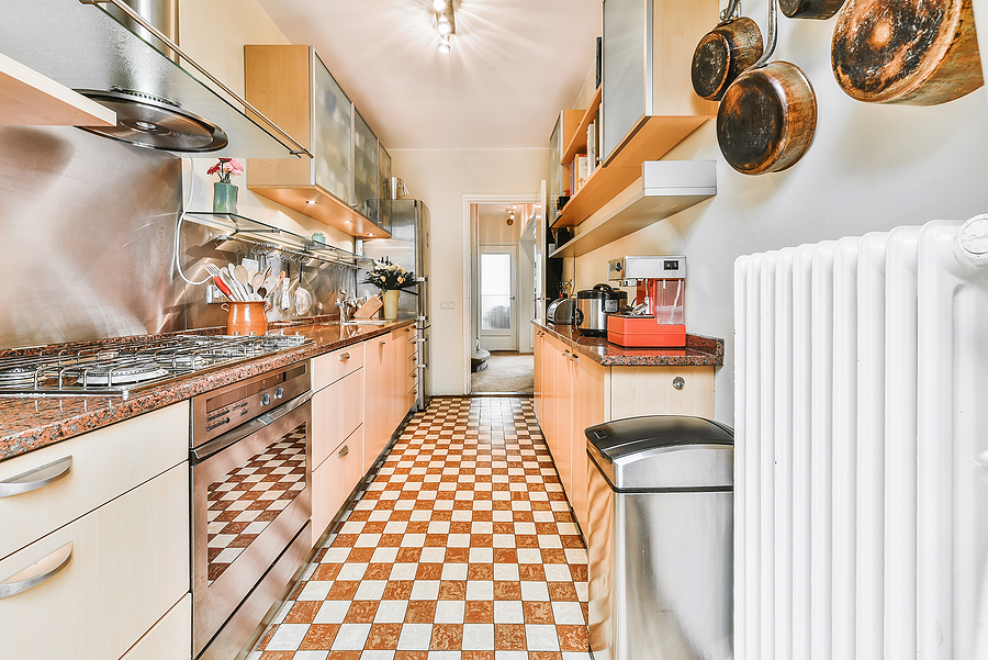 Modern galley kitchen with wooden cabinets and minimalist design.