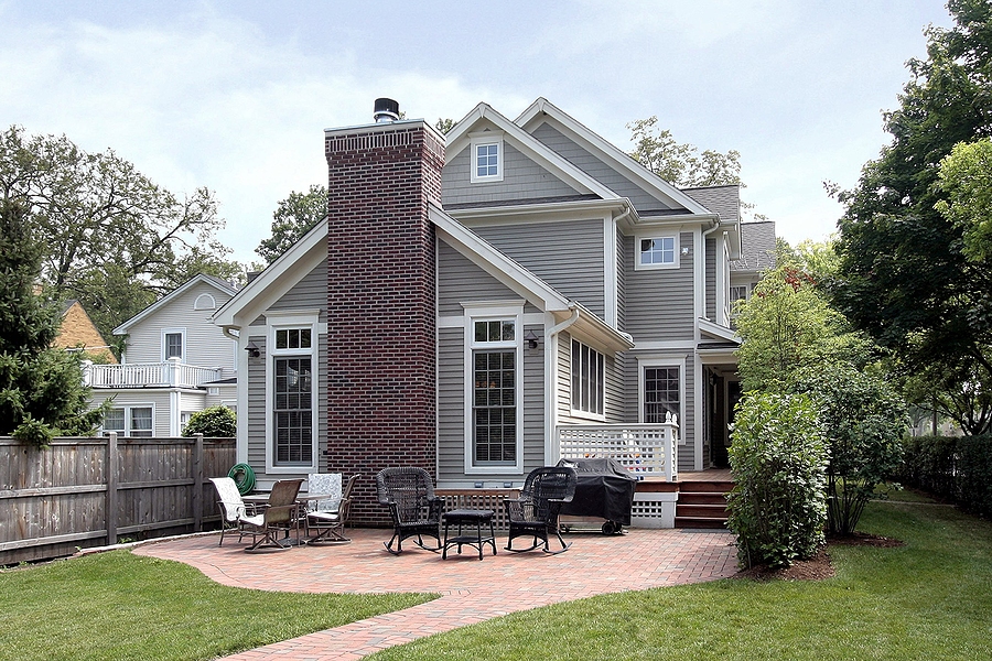 Rear exterior view of luxury home with new windows.