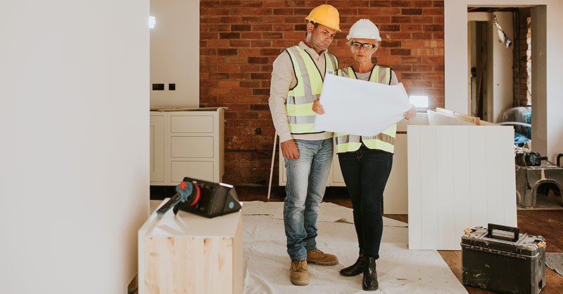 home improvement contractors looking over plans