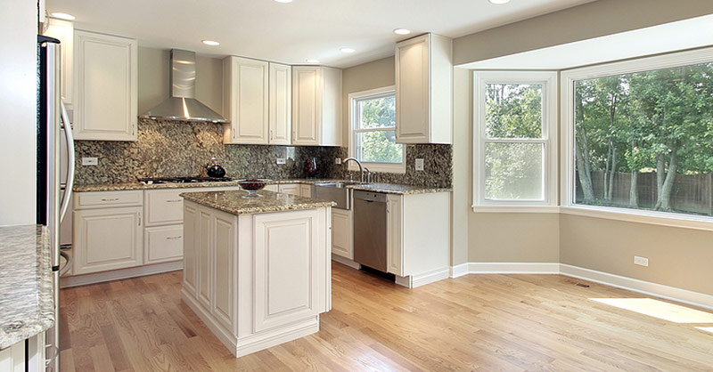 kitchen renovation with 1 island and a stainless steel hood