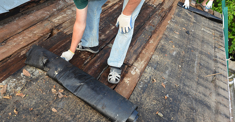 contractors working on a roof tear off