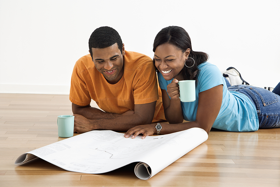 Married couple looking over home improvement plans.