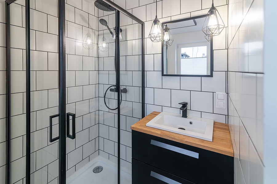 Modern bathroom with a washbasin and a shower. White tiles on the walls