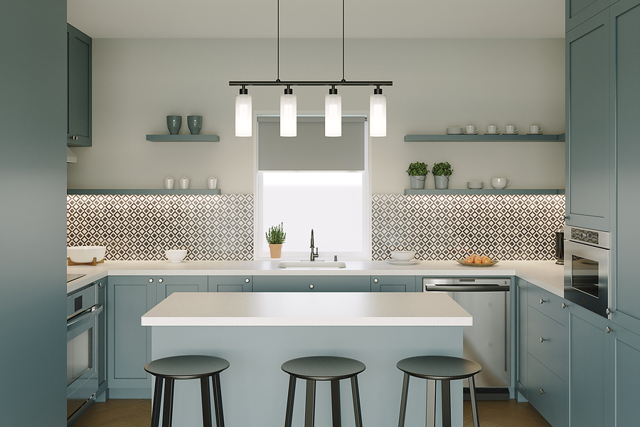 Small kitchen with large window, white countertops, small island, overhanging light fixture, tile backsplash, and aquamarine cabinetry.