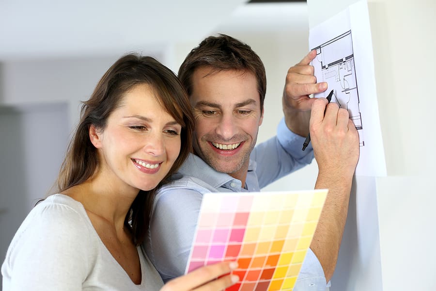 Couple looking at paint samples and planning their home renovation. 